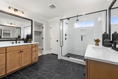 a bathroom with marble flooring and wooden cabinets