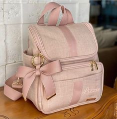 a pink backpack sitting on top of a wooden table