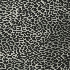 an animal print fabric with black and white spots on the top, as well as dark grey