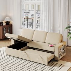 a living room with a couch, coffee table and storage compartment in it's center