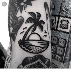 a man's arm with a palm tree and beach scene tattoo on the left forearm