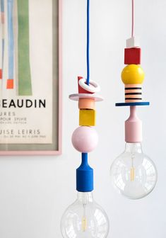 two colorful light bulbs hanging from the ceiling