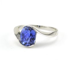 This 2.6 carat lab grown tanzanite 7x9mm oval shaped gemstone is set in a sterling silver setting with a rhodium finish. Oval gemstone has a checkerboard cut so it sparkles. The rhodium finish protects the silver and makes for easy care. This ring is a size 7 and can be special ordered in another size. To clean: simple wash in a mild detergent like Dawn with a tooth brush. You do not want to put a rhodium plated piece of jewelry in any harsh chemicals. Style Number: 19155 Metal: 925 Sterling Silver Gemstone: Lab Grown Tanzanite from Corundum (Sapphire) Dimensions: 3/8 inch wide Modern Oval Sapphire Ring With Accent Stones, Timeless Silver Sapphire Ring With Oval Shape, Modern Silver Oval Sapphire Ring, Modern Oval Tanzanite Ring, Modern Oval Tanzanite Sapphire Ring, Modern Silver Sapphire Ring Oval Shaped, Oval Tanzanite Sapphire Ring, Timeless Oval Tanzanite Rings, Oval Tanzanite Ring In White Gold