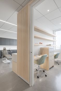 an office with white walls and wooden slats