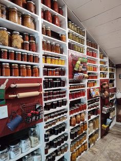 the shelves are filled with many different kinds of jars and containers, including jams