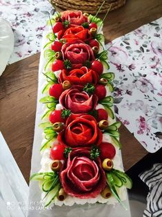 a long table with flowers and tomatoes on it