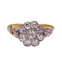 an antique diamond cluster ring in yellow gold