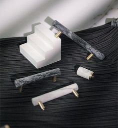 marble and brass accessories on black cloth