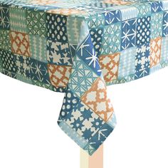 a blue and orange table cloth with an abstract design on the top that has snowflakes all over it