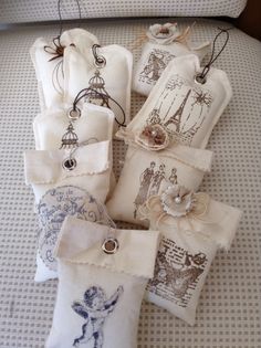 several decorative items are laid out on a bed with white linens and tags attached to them