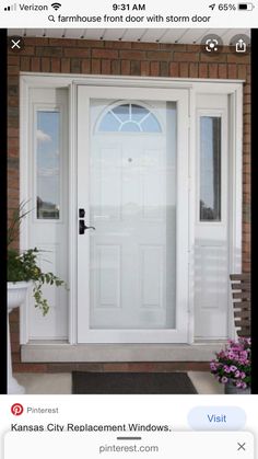 a white front door with two flower pots on the side and a bench in front