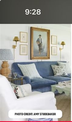 a living room with blue couches and pictures on the wall above them that reads 9 / 28 photo credit - any studiobaker