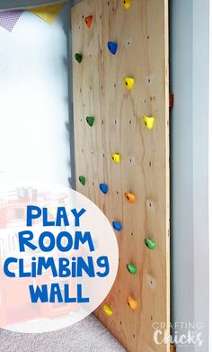 a climbing wall made out of plywood with the words play room climbing wall above it