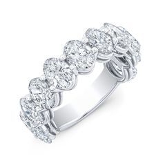 a white gold ring with five pear shaped diamonds on the sides and an intricate band