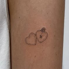 two hearts tattoo on the left arm