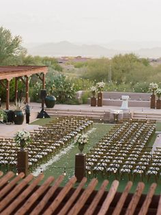 an outdoor wedding setup with white flowers and greenery