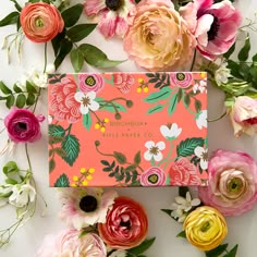 an orange and pink floral box surrounded by flowers