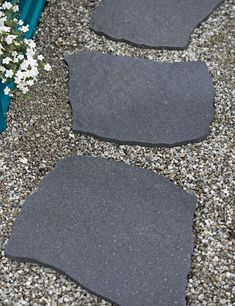 two gray car mats sitting on top of gravel