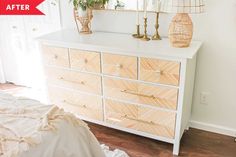 a white dresser with gold handles and drawers