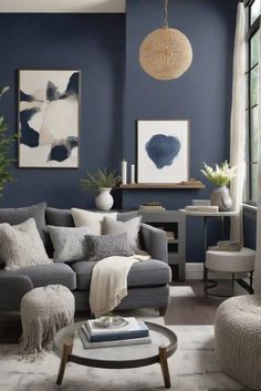 a living room with blue walls and grey couches, white rugs and pictures on the wall