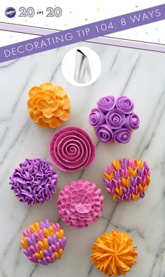 colorful cupcakes decorated with flowers on a marble table