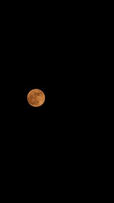 the full moon is seen in the dark sky with no clouds on it's side