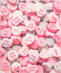 candy hearts with the words i love you written on them in pink and white colors