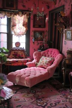 a living room with pink walls and furniture