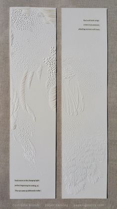 two white bookmarks with different designs on them