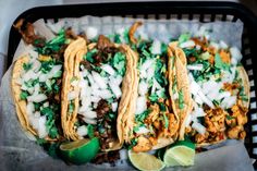 three tacos with meat, onions and cilantro