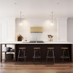 a kitchen with two bar stools and an island in front of the countertop