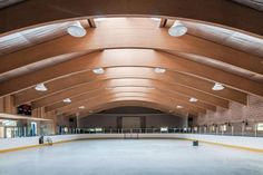 an empty skating rink with lights on the ceiling