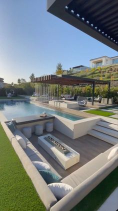 an outdoor living area next to a pool