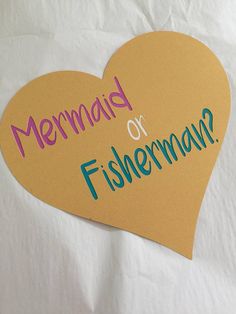 a paper heart with the words mermaid or fisherman on it