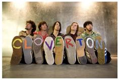 five men sitting in front of the word love written on their shoes, all lined up