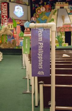 an empty church with rows of pews and banners on the sidelines for people to sit in