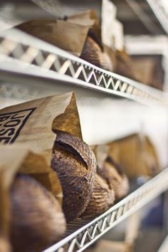 some breads are sitting on shelves in a store