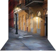 an empty city street at night with no one on the sidewalk or in front of it