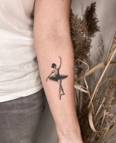 a ballerina tattoo on the left arm