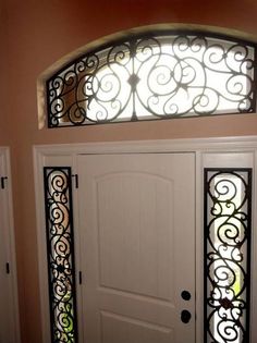 the front door is decorated with wrought iron designs