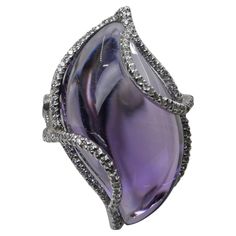 Please check out the HD video! Here is a super unique Amethyst and diamond cocktail statement ring. It is set in 18k white gold and diamonds. The XL 23.25 cts center amethyst is stunning. The violet-purple color shifts from light to dark depending on the angle you look at it. Please refer to the video. This is a very clean stone with high transparency. All the photos are magnified and in HD for your reference. There are 167 diamonds totaling 0.51 cts in this setting. It is full of life! A piece Diamond Cocktail Ring, Diamond Cocktail Rings, Bracelet Design, Violet Purple, Crown Jewels, Jewelry Business, Jewelry Rings Engagement, Cocktail Ring, Cocktail Rings