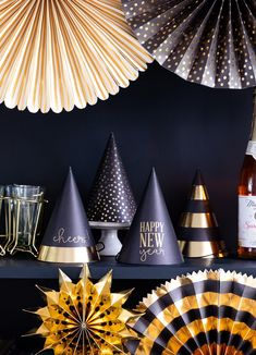 black and gold party hats, champagne bottles, and paper fans are all on display