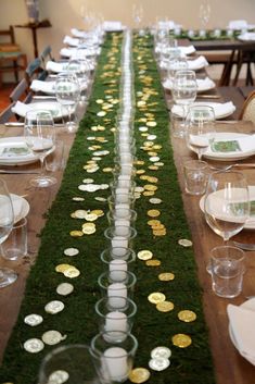 a long table is set with plates and place settings for guests to sit down at