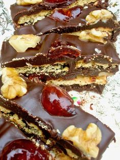 chocolate bars with cherries and walnuts are stacked on top of eachother