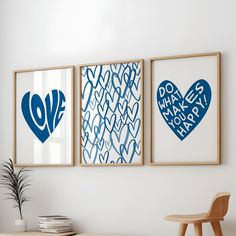 three framed art pieces hang on the wall above a table with a potted plant