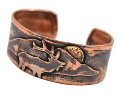 PRICES MAY VARY. Durable unisex cuff bracelet is crafted using reclaimed pure copper 1-inch-wide cuff is enhanced with an elk and mountain motif Rustic patina highlights the elk design and emphasizes the organic characteristic of copper Available in adjustable medium and large sizes (see description below for sizing detail) Artisan-crafted in the USA Adorned with an elk and mountain design, this copper cuff bracelet is individually handcrafted using rustic reclaimed copper. The cuff is provided Hammered Copper Jewelry, Copper Properties, Copper Uses, Mountain Design, Soldering Jewelry, Copper Cuff Bracelet, Cuff Jewelry, Copper Cuff, Rustic Jewelry