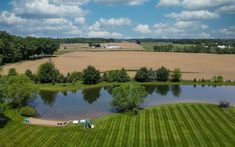 an aerial view of a large field and lake