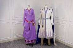 two mannequins are dressed in purple and white outfits, standing next to each other