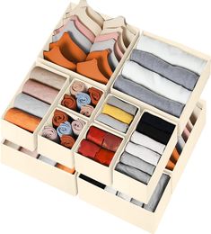 an open drawer filled with lots of different colored ties and scarves on top of each other