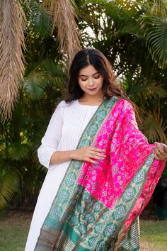 Celebrate any occasion in style with our silk blend patola dupatta. Crafted with care, each piece is elegant and unique. Enjoy the exclusivity of our limited edition collections and savor the slow fashion journey with us. Care: Consider dry cleaning or hand washing as preferable options, as machine washing may increase the likelihood of damaging the dupatta. Dupatta Length: Approx 2 meters * 0.5 metersUsage: Evening, Weddings, Festivals, Parties or any other special occasions.Perfect Gifting Solution: They also make ideal gifts for daughters, mothers, grandmothers, colleagues, partners, students, girlfriends, brides, bridesmaids, wives, wedding gifts, Ramadan, Eid gifts, Diwali Our soft and luxurious Patola cotton-silk dupatta, is perfect for any occasion. This dupatta is the perfect acces Pink Slub Silk Dupatta For Designer Wear, Pink Cotton Silk Traditional Wear With Dupatta, Pink Slub Silk Dupatta For Transitional Season, Diwali Slub Silk Dupatta, Pink Cotton Silk Dupatta For Eid, Semi-stitched Bandhani Print Dupatta, Cotton Silk Dupatta With Bandhani Print For Wedding, Designer Pink Silk Dupatta, Festive Ikat Print Katan Silk Dupatta